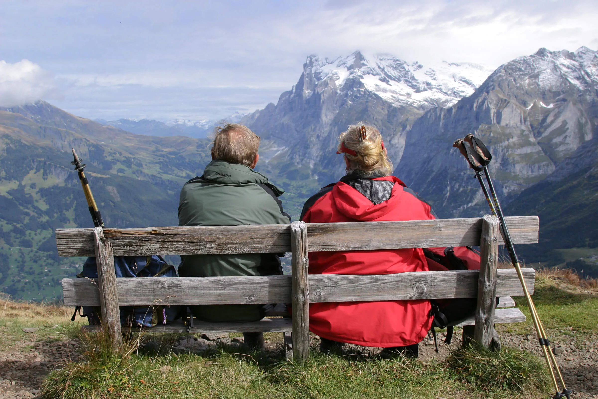 A well-situated bench rewards these hikers with a spectacular alpine panorama