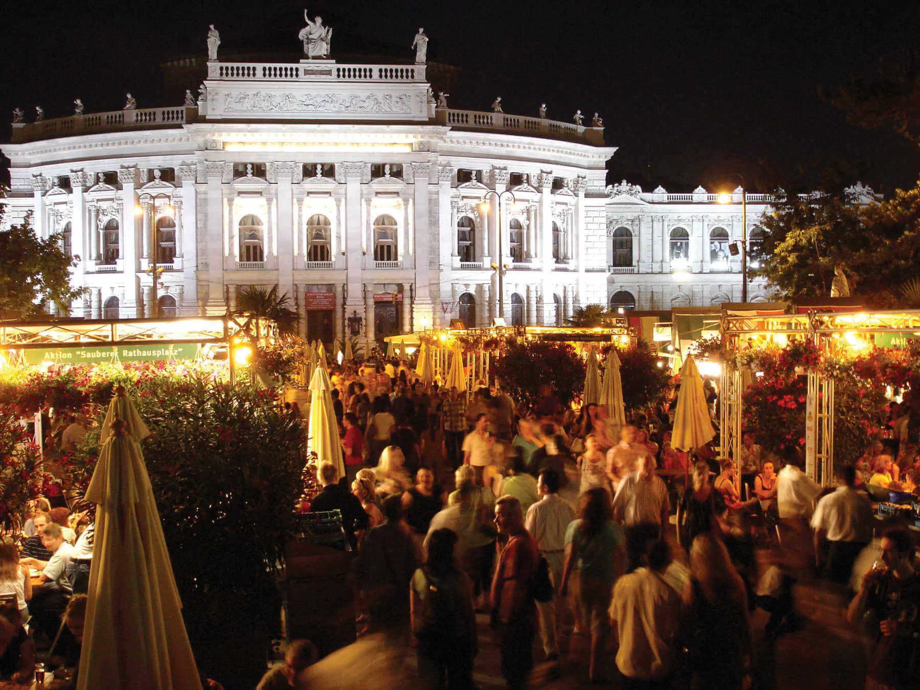 On a summer evening in Vienna, people drink, munch, and mingle before the outdoor opera begins