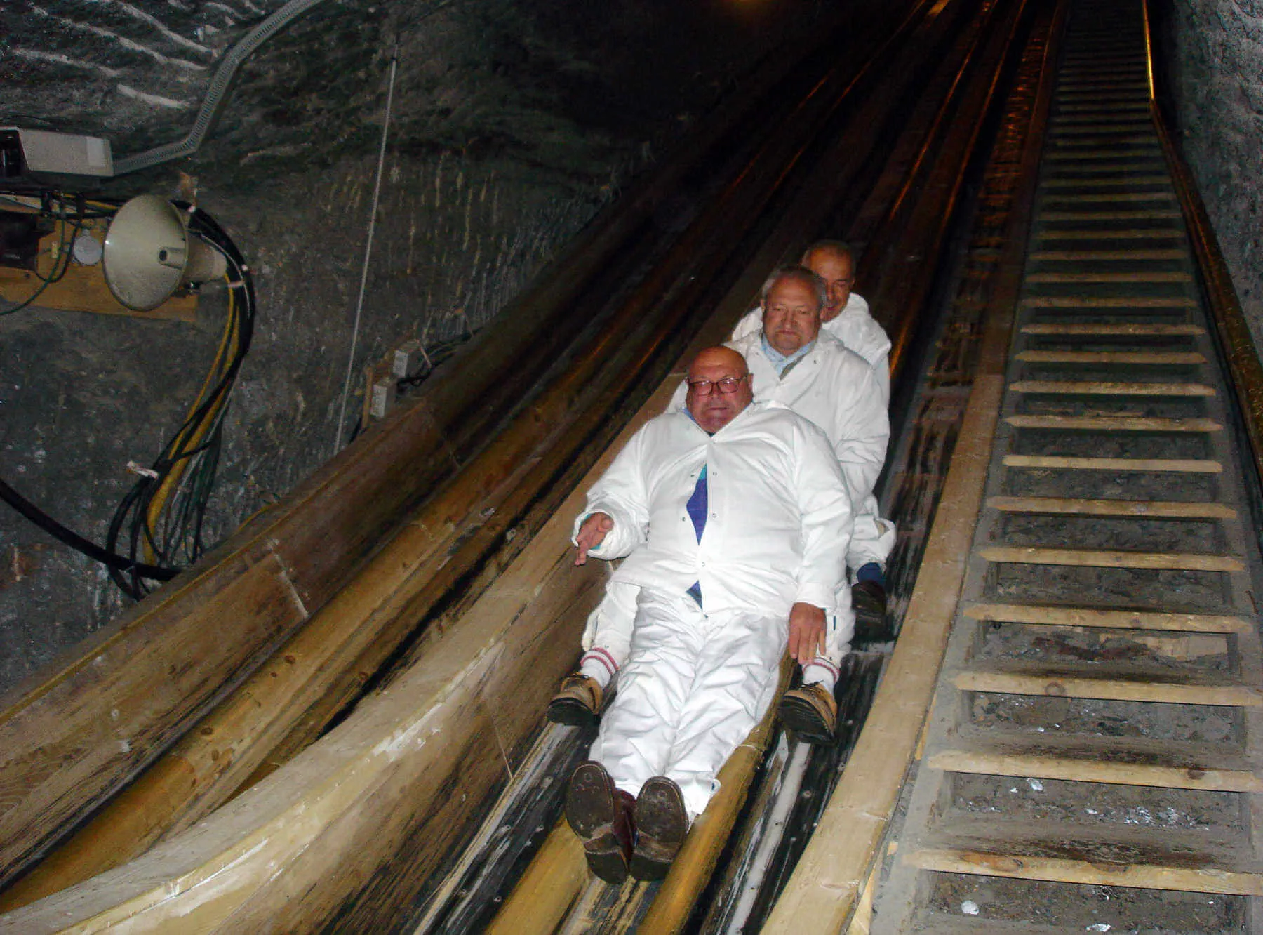 Visitors to Hallstatt’s salt mine slide down two banisters. At the end, they find out their time and receive an automatic souvenir photo