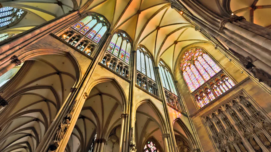 The nave of Cologne's Gothic cathedral towers 140 feet above its visitors